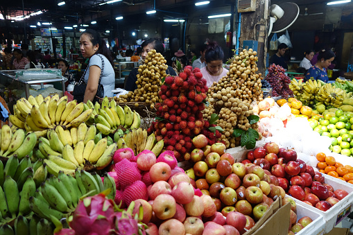 Siem Reap, Cambodia- Oct 21, 2016: Woman selling vegetables and fruits in the market of Siem Reap, Cambodia