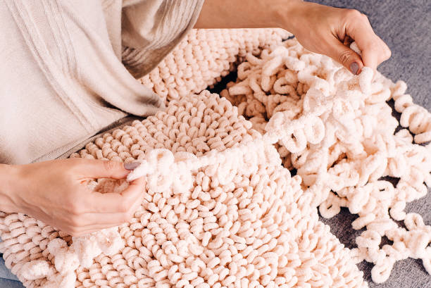 istock Knits made from thick soft yarn. Soft knitted cushions made of thick yarn. 1324294983