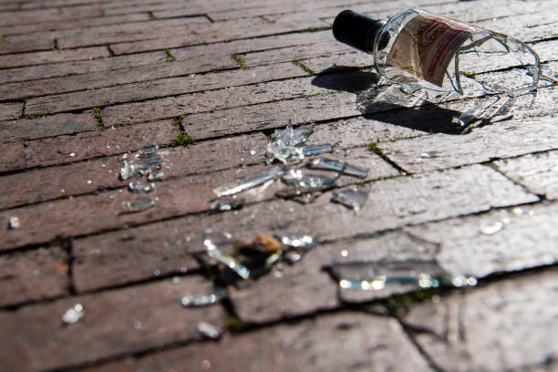 istock Broken glass liquor bottle on brick road. 1324297279