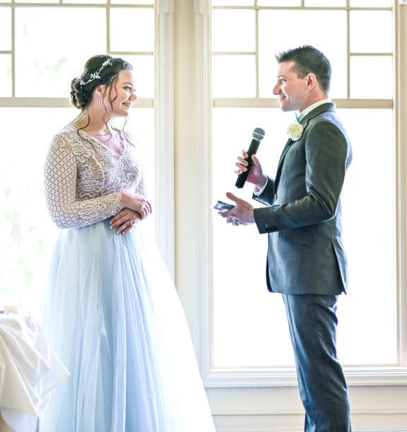 istock Bride and groom make speeches with microphone on their wedding day at the reception 1324299276