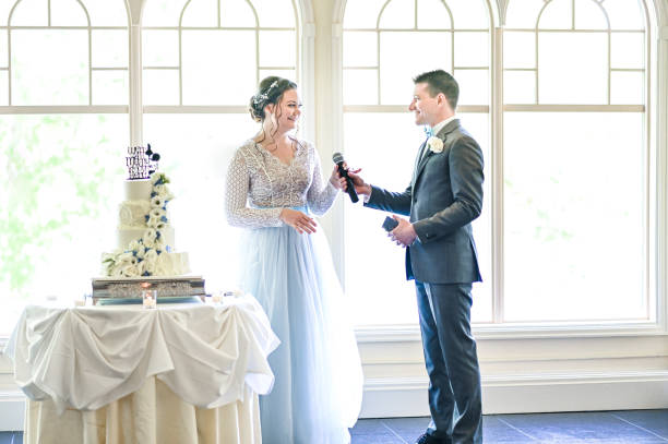 istock Bride and groom make speeches with microphone on their wedding day at the reception 1324299287