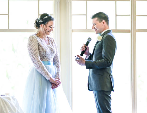istock Bride and groom make speeches with microphone on their wedding day at the reception 1324299348