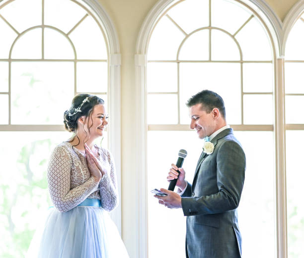 istock Bride and groom make speeches with microphone on their wedding day at the reception 1324299505