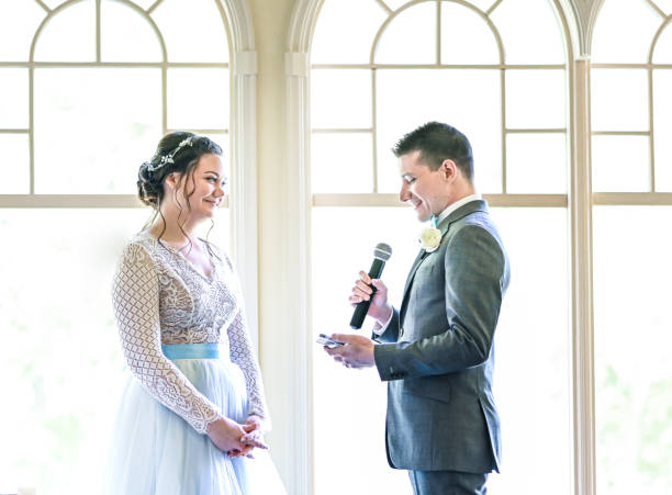 istock Bride and groom make speeches with microphone on their wedding day at the reception 1324299601