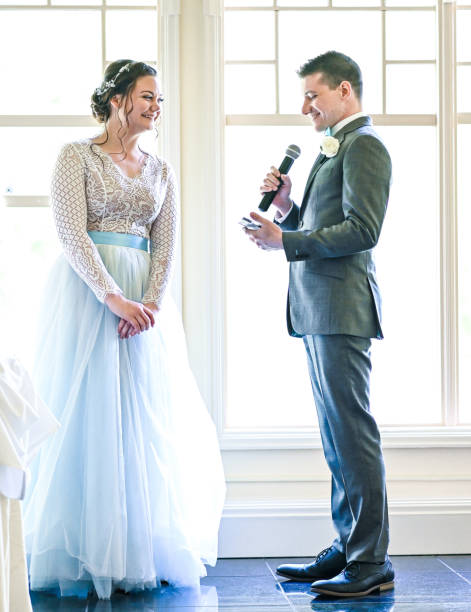 istock Bride and groom make speeches with microphone on their wedding day at the reception 1324300777