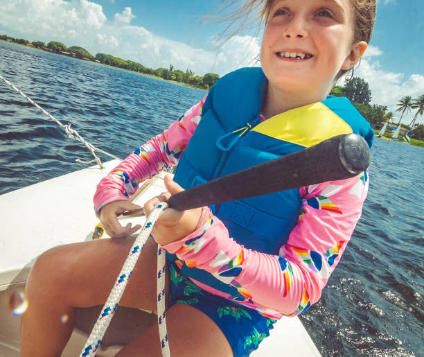istock Camper manning a small sailboat on a scenic summer lake 1324304158