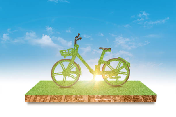 istock Green bicycle driving green grass field over blue sky background 1324310204