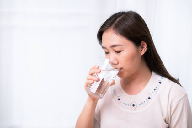 istock Asian young woman drinking a water. 1324310252