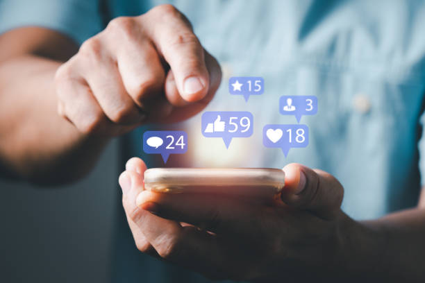 istock a man using smart phone typing to communicate with others through emoji and text online. concept with notification icons of like, message, email, comment and star above smartphone screen 1324312487