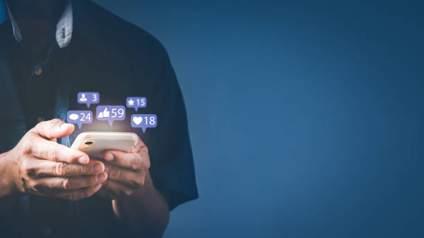 istock a man using smart phone typing to communicate with others through emoji and text online. concept with notification icons of like, message, email, comment and star above smartphone screen 1324312491