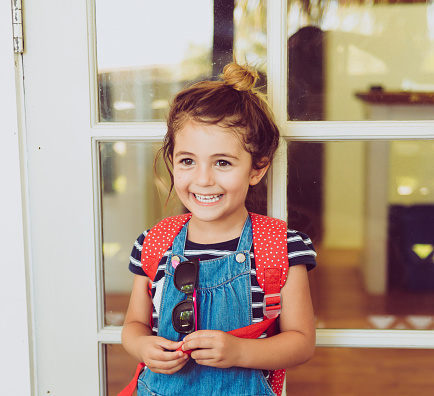 Adorable little girl in a backpack