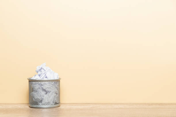 istock Crumpled paper ball in a wastepaper basket. 1324315710