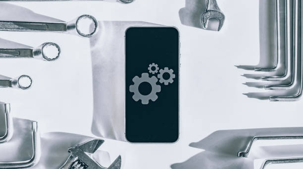 istock Repair phone. Technician workplace with phone and special repairing tools. Disassembling, diagnostic and repairman smartphone. 1324324398