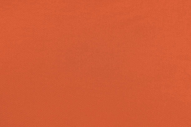 istock Red orange homogeneous background with a textured surface 1324325190
