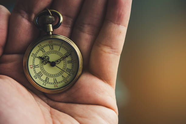 istock An ancient pocket watch placed on hand. 1324329094