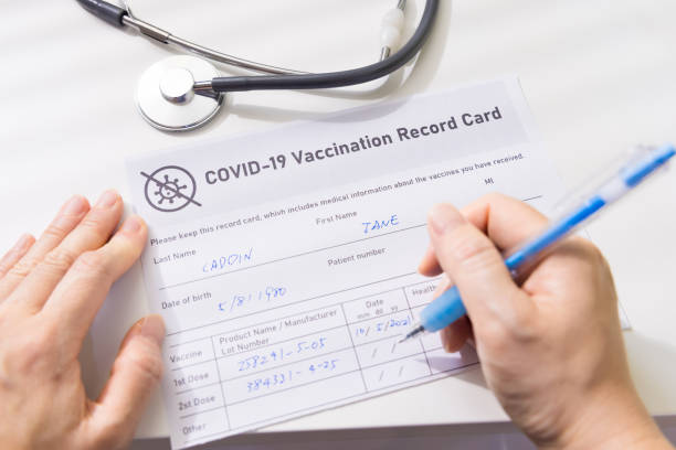 istock woman write vaccination record card 1324330031
