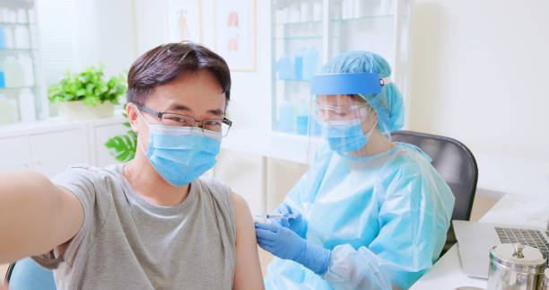 istock man take selfie inject vaccine 1324330155