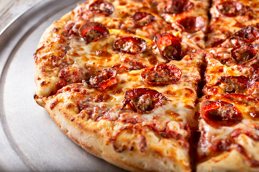 A view of a pepperoni and sausage pizza.