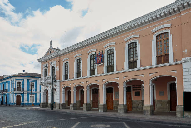 istock Building with neoclassical architecture with wide portals and large windows and thick pillars in a brick street. 1324334045