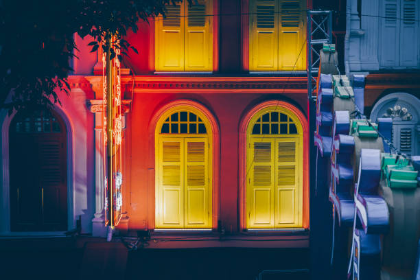 Colourful illuminated facade of a Chinese building in the red light district of Chinatown in Singapore seen at night.