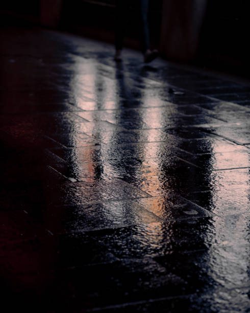 istock Reflection on a wet pavement in city streets 1324337960