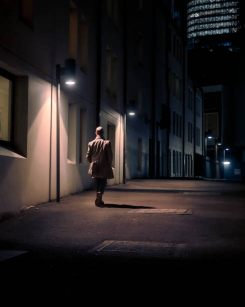 istock Man walking alone with overcoat and bag 1324337988