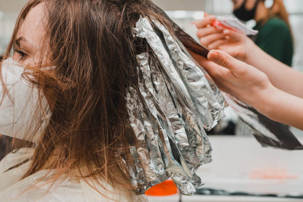 The work of hairdressers during the world quarantine, the process of applying hair dye. The work of hairdressers during the world quarantine, the process of applying hair dye. new comb over stock pictures, royalty-free photos & images