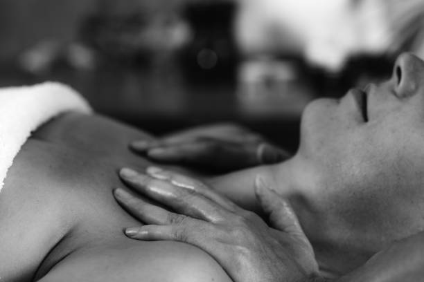 Woman enjoying Ayurvedic shoulders massage with ethereal oils