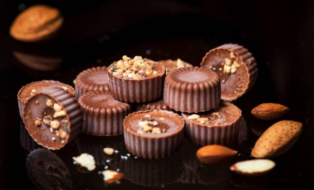 istock Chocolate candies dessert with almonds on dark table 1324345534