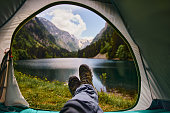 View of the lake and mountains through the open window of the tent