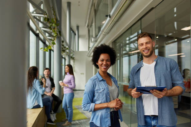 istock Two business people discussing document in office hallway 1324346084