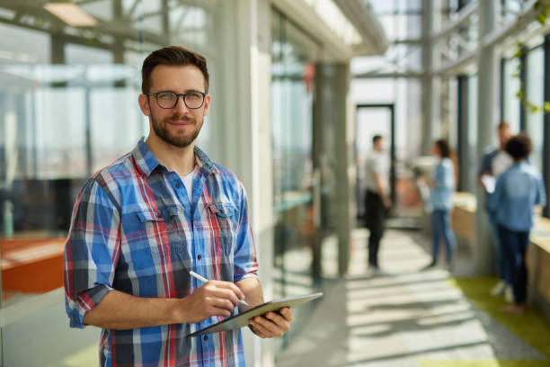 istock A successful male web designer using digital tablet in the office hallway 1324346642