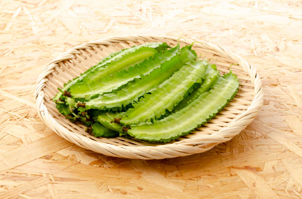 istock Fresh Winged beans on a bamboo sieve on a plywood Board background 1324347874