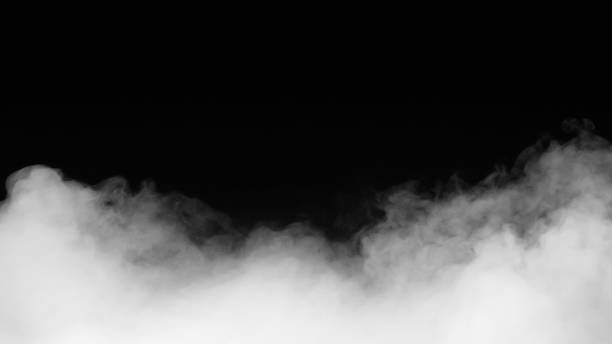 istock White smoke or fog isolated on black background. 1324347924