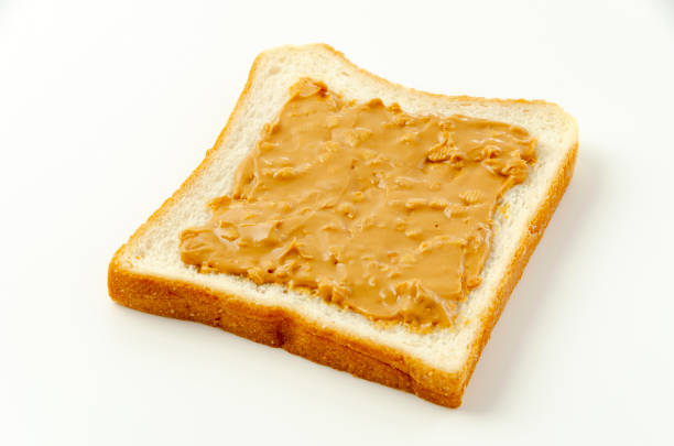 istock peanut butter on a slice of white bread. 1324347949