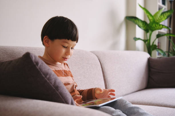 istock Child using digital tablet and watching movie at home 1324348182