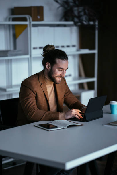 istock Handsome Businessman With Beard Using Laptop At Room 1324348204