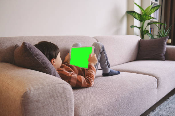 Child using digital tablet and watching movie at home