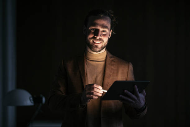 istock Late Night Work At Home: Happy Businessman With Beard Using Digital Pen 1324348232