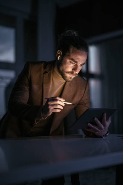 istock Late Night Work At Home: Young Businessman With Beard Using Tablet 1324348241