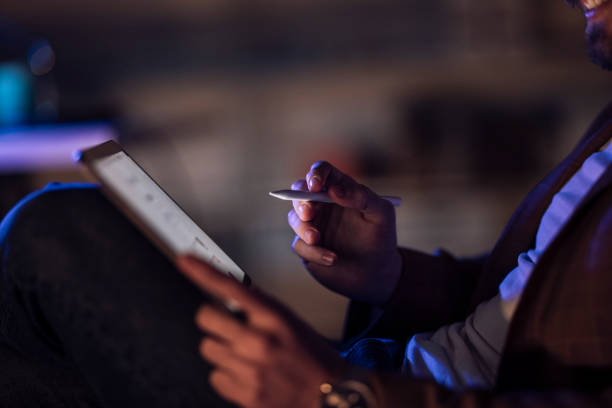istock Late Night Work At Home: Relaxed Anonymous Businessman With Beard Using Tablet 1324348253