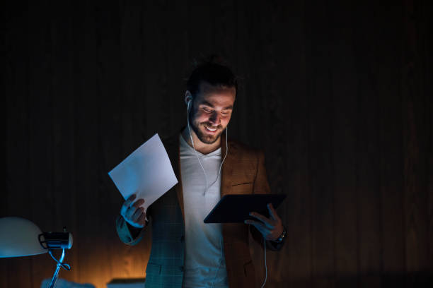 istock Late Night Work At Home: Businessman Having Video Call Holding Documents 1324348256