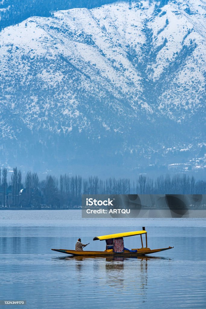 A beautiful view of Dal Lake in winter, Srinagar, Kashmir, India. A view of Dal Lake in winter, and the beautiful snowcapped mountain range in the background in the city of Srinagar, Kashmir, India. Jammu and Kashmir Stock Photo