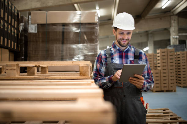 istock Portrait of storage worker supervisor typing on tablet computer and organizing new goods arrival to the warehouse. 1324349935