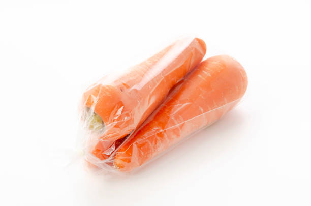 fresh Carrot in plastic bag on white background
