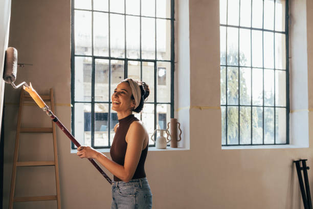 DIY home renovation work. Woman in casual wear. The shot is executed with available natural light, and the copy space has been left.