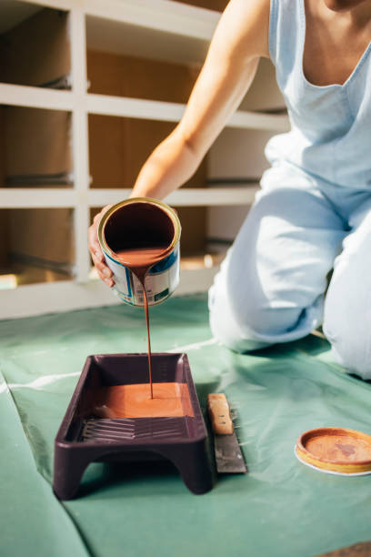 istock Unrecognizable Woman Pouring Paint in a Tray 1324350637