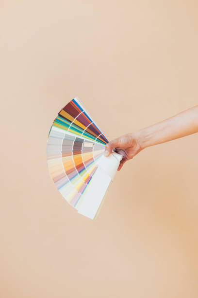Woman's Hand Holding Color Swatches Book