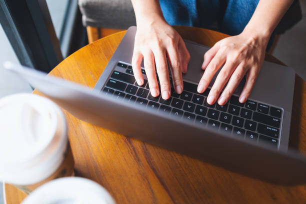istock a woman working and typing on laptop computer keyboard on the table 1324351669