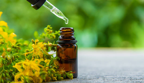 An essential oil extract of St. John's wort herb. Selective focus. An essential oil extract of St. John's wort herb. Selective focus. Nature. st john's plant stock pictures, royalty-free photos & images